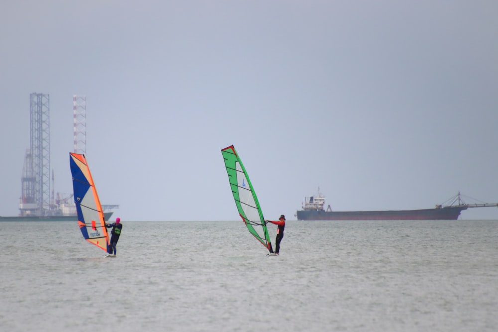 blue and yellow sail boat on sea during daytime