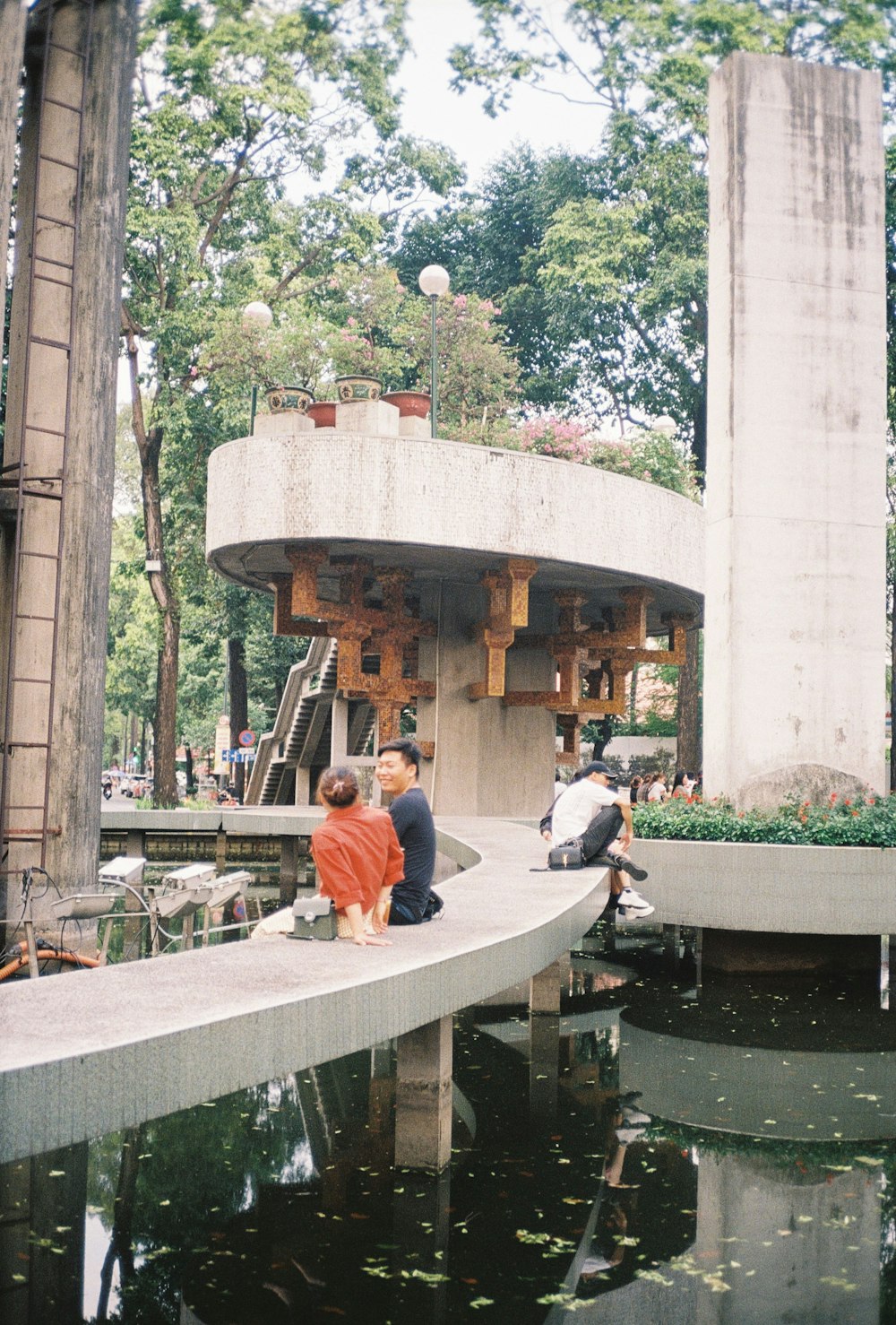 man in red long sleeve shirt sitting on bench