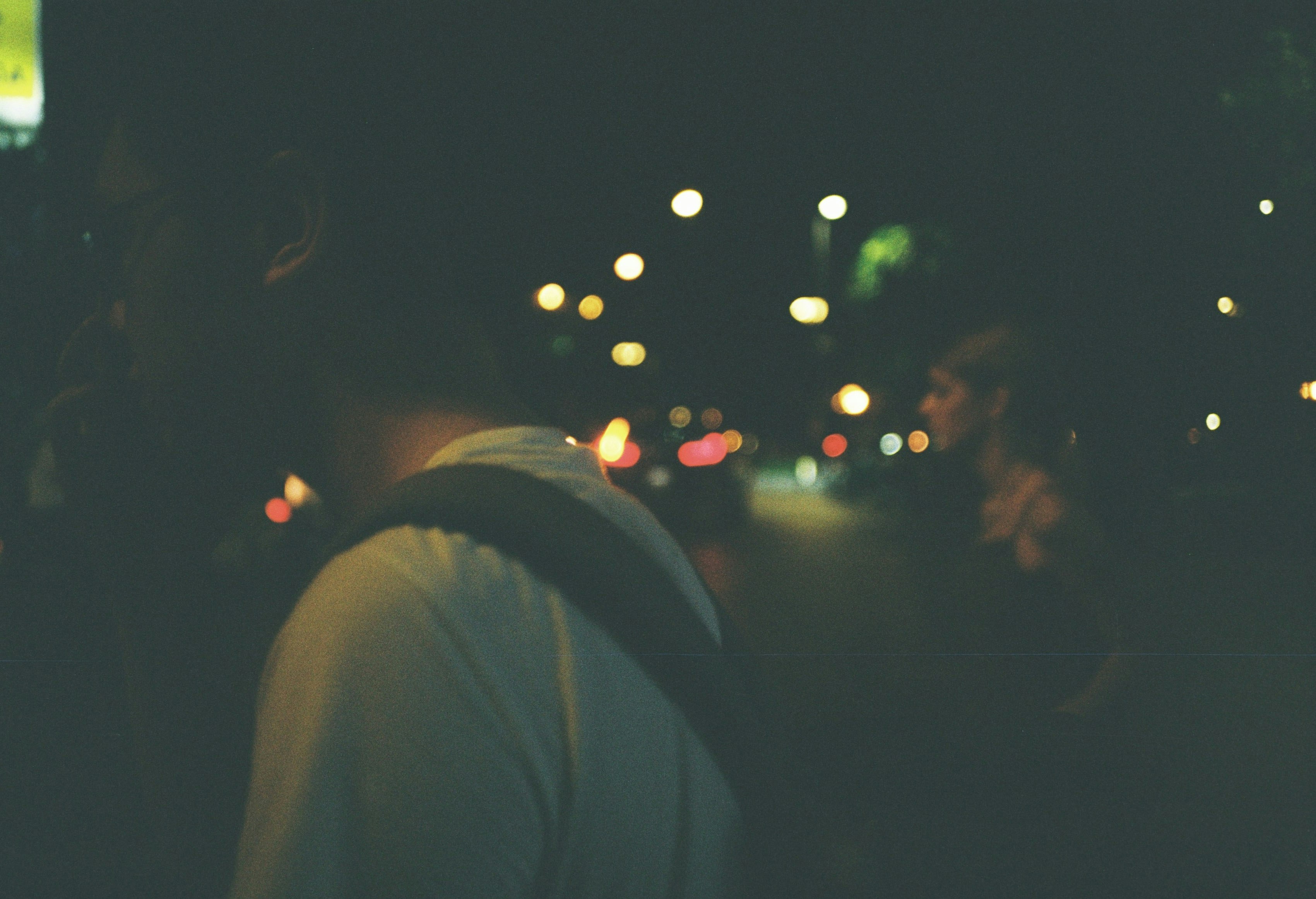 man in black hoodie standing during night time