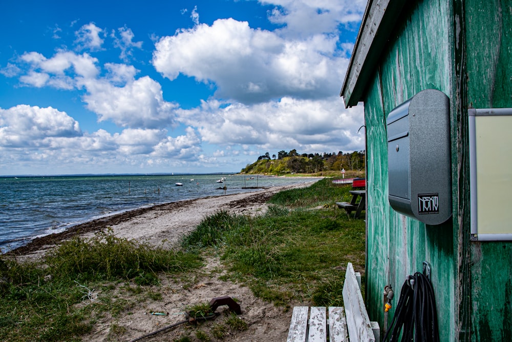 white and blue wooden house near body of water during daytime