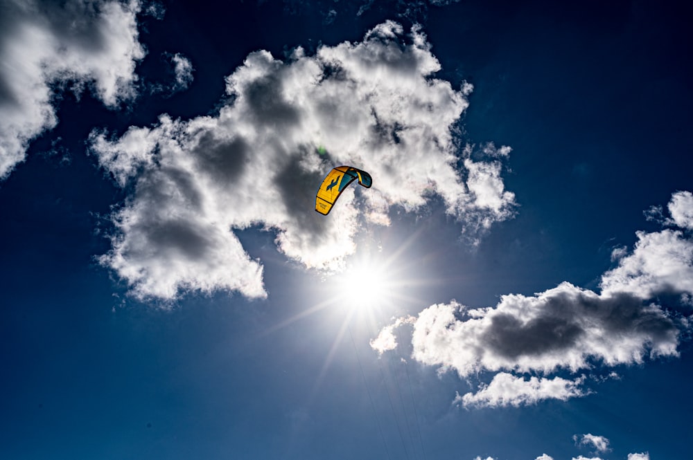 yellow and red parachute under blue sky during daytime