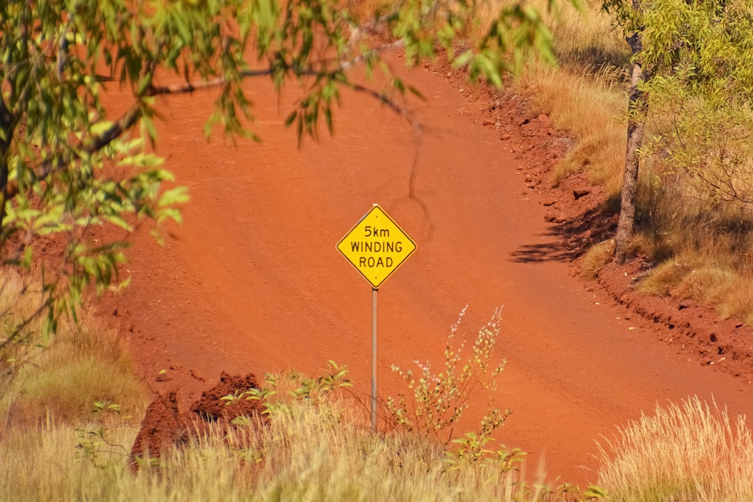 brown and yellow road sign