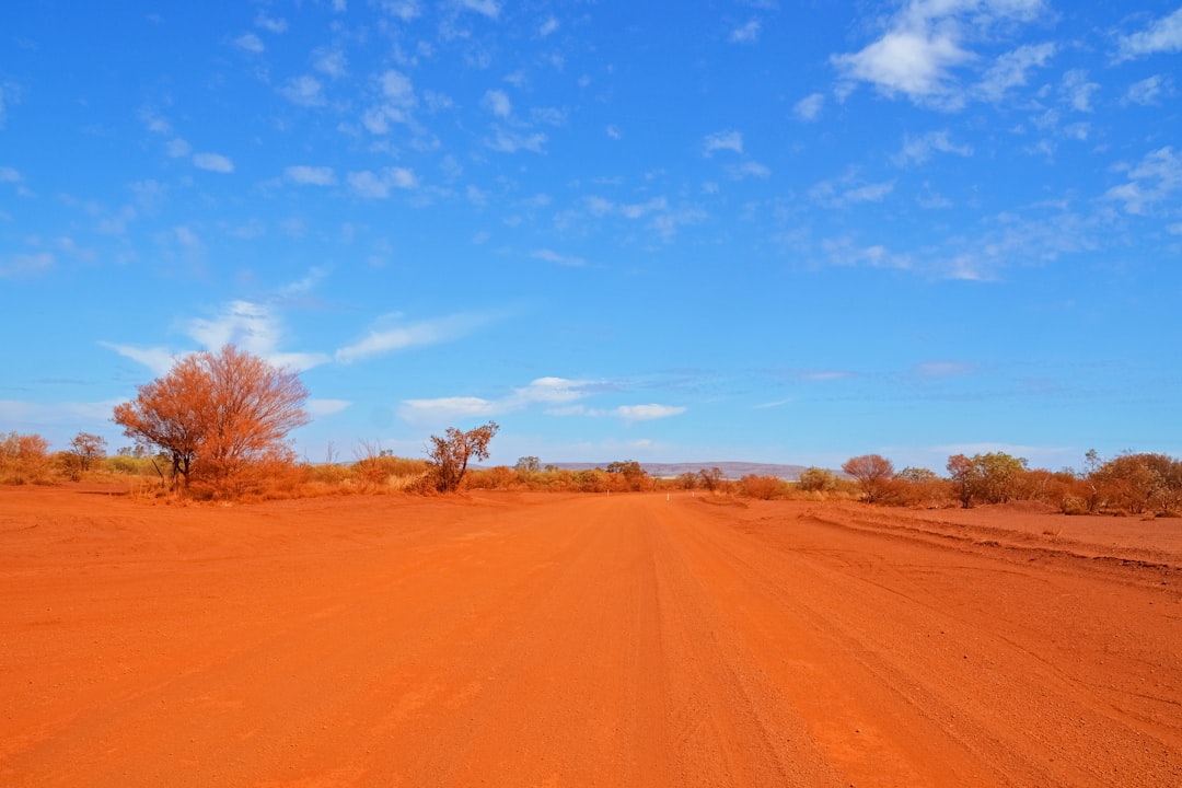 brown sand field under blue sky during daytime