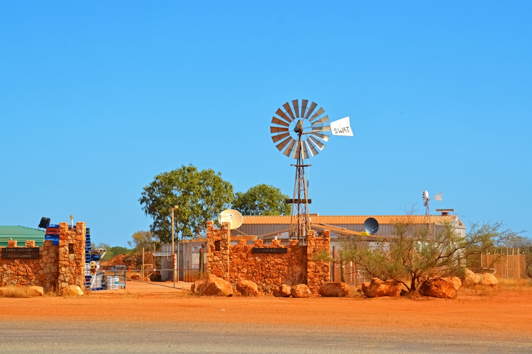 brown and white windmill under blue sky during daytime