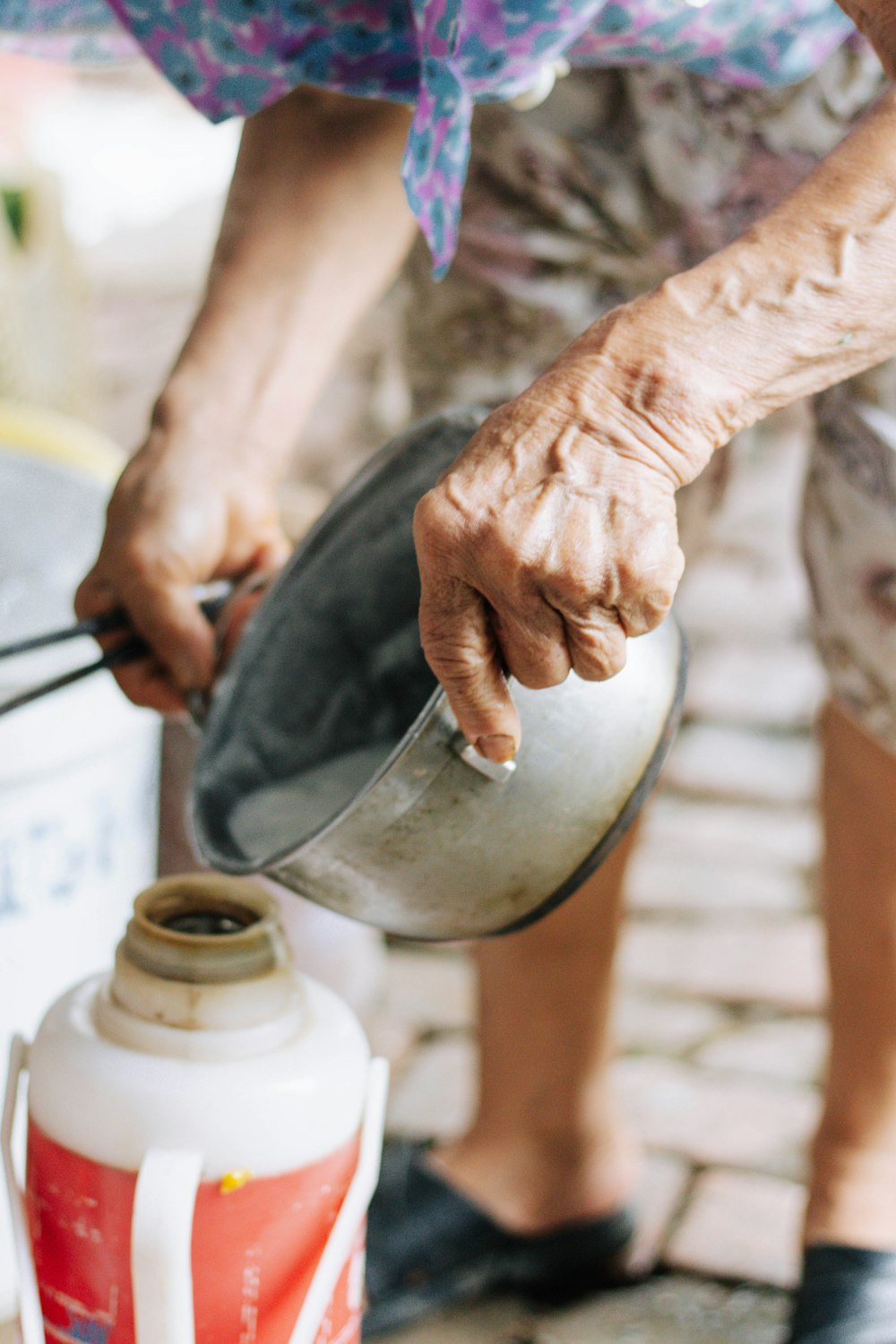 person pouring water on stainless steel bowl