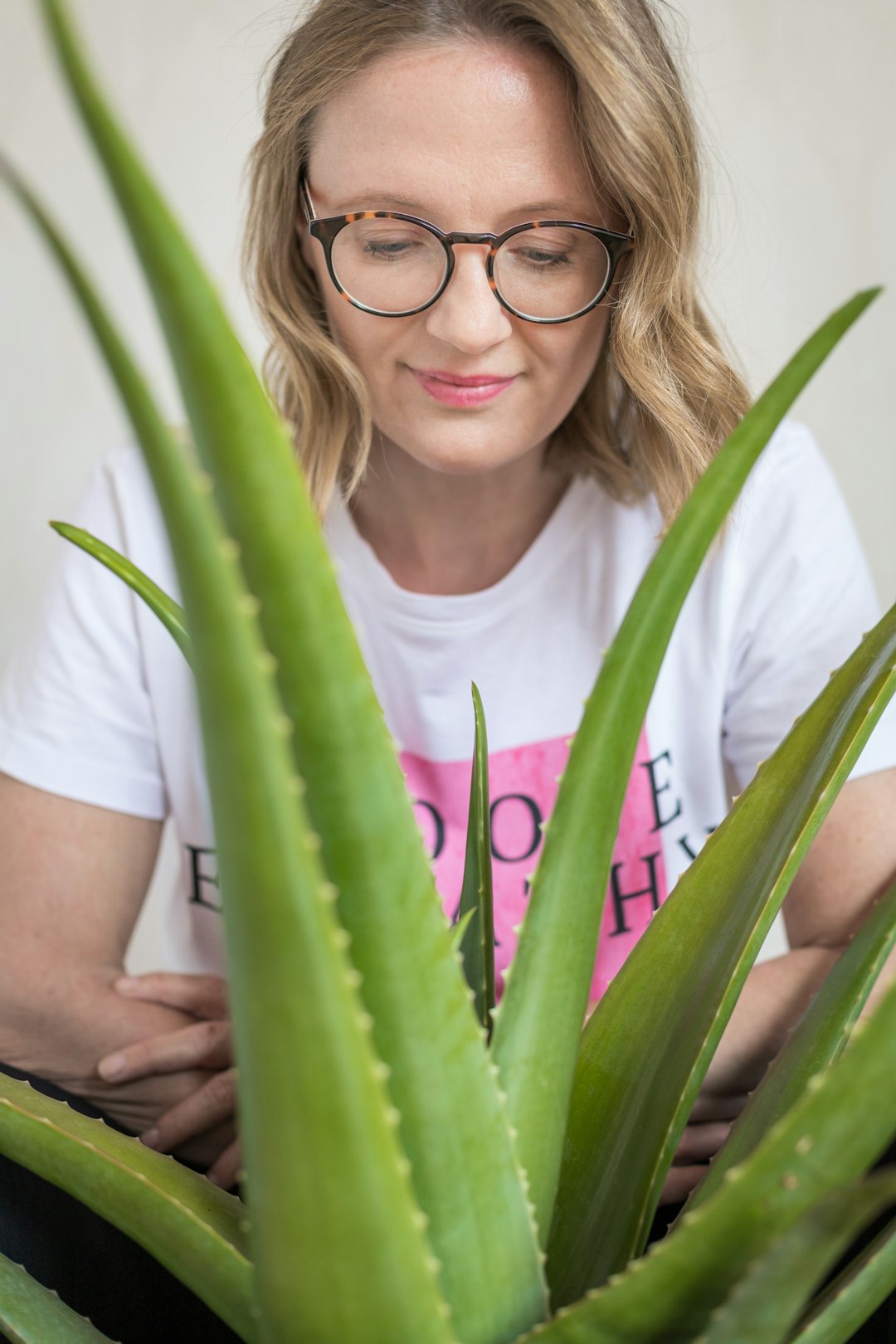 girl in white crew neck t-shirt wearing eyeglasses with brown frame