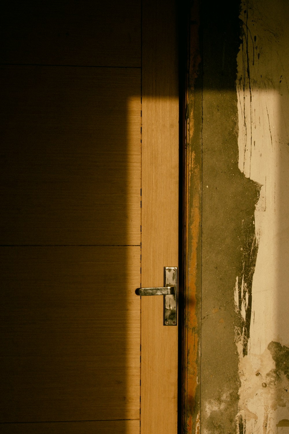 brown wooden door with silver door lever