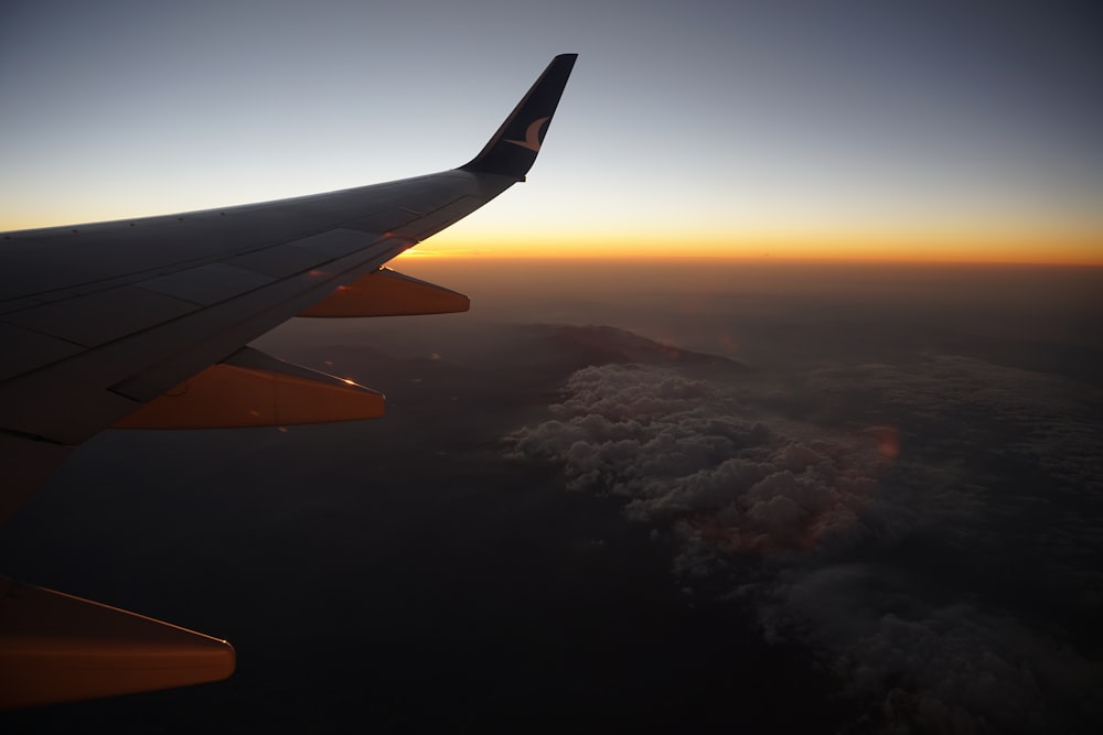 airplane wing over the clouds during daytime