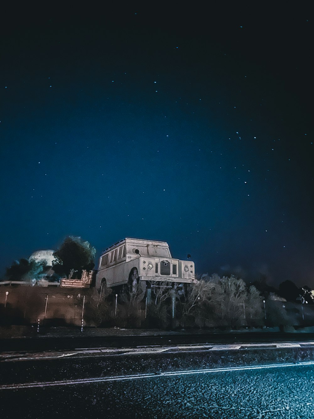 white concrete building near body of water during night time