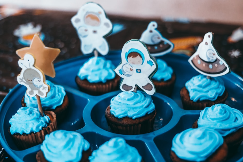 cupcakes with white and blue icing on top