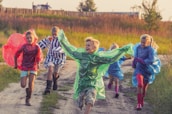 Bright and cheerful children playing outdoors with a rainbow in the background.