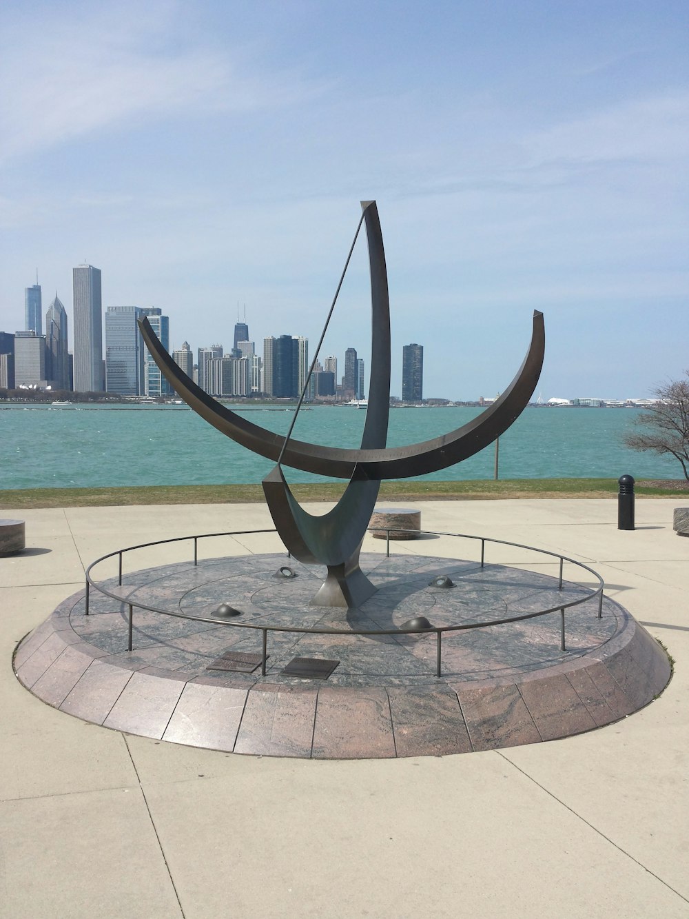 gray concrete fountain near body of water during daytime