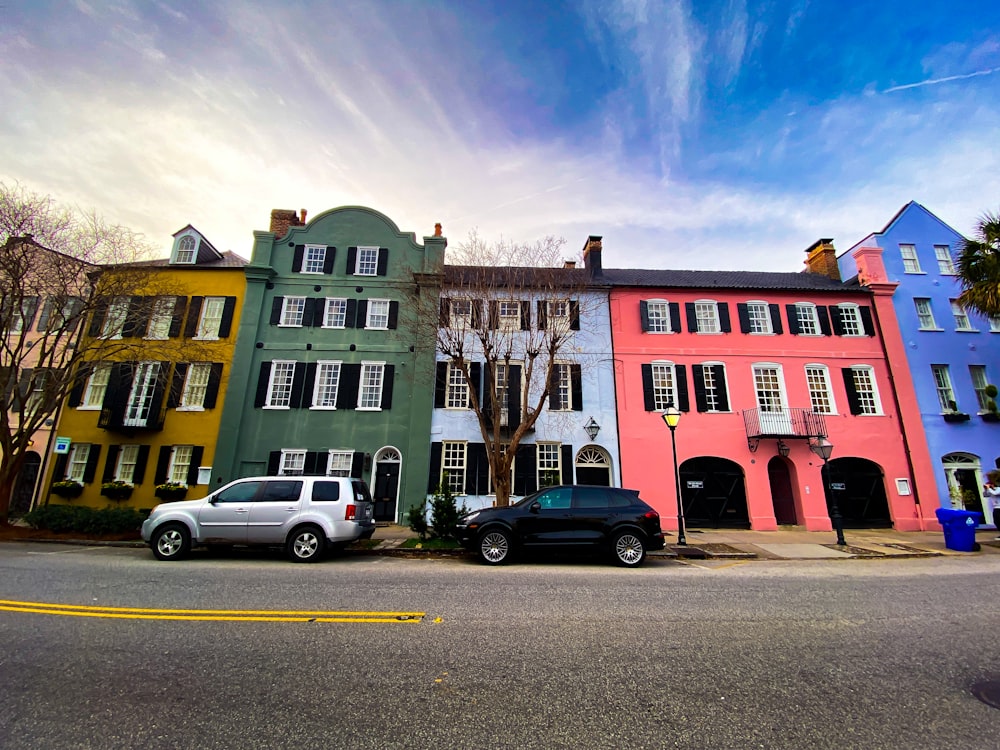 cars parked in front of red building