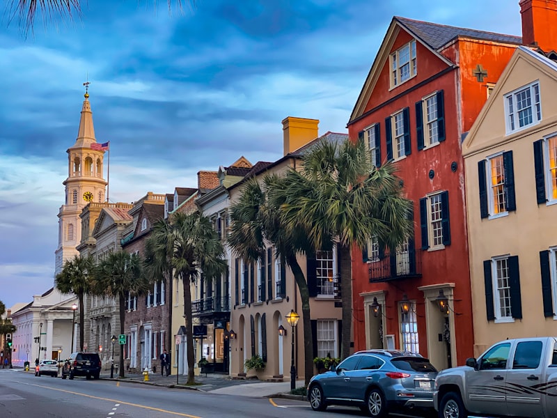Historic Charleston buildings with colorful facades and church steeple