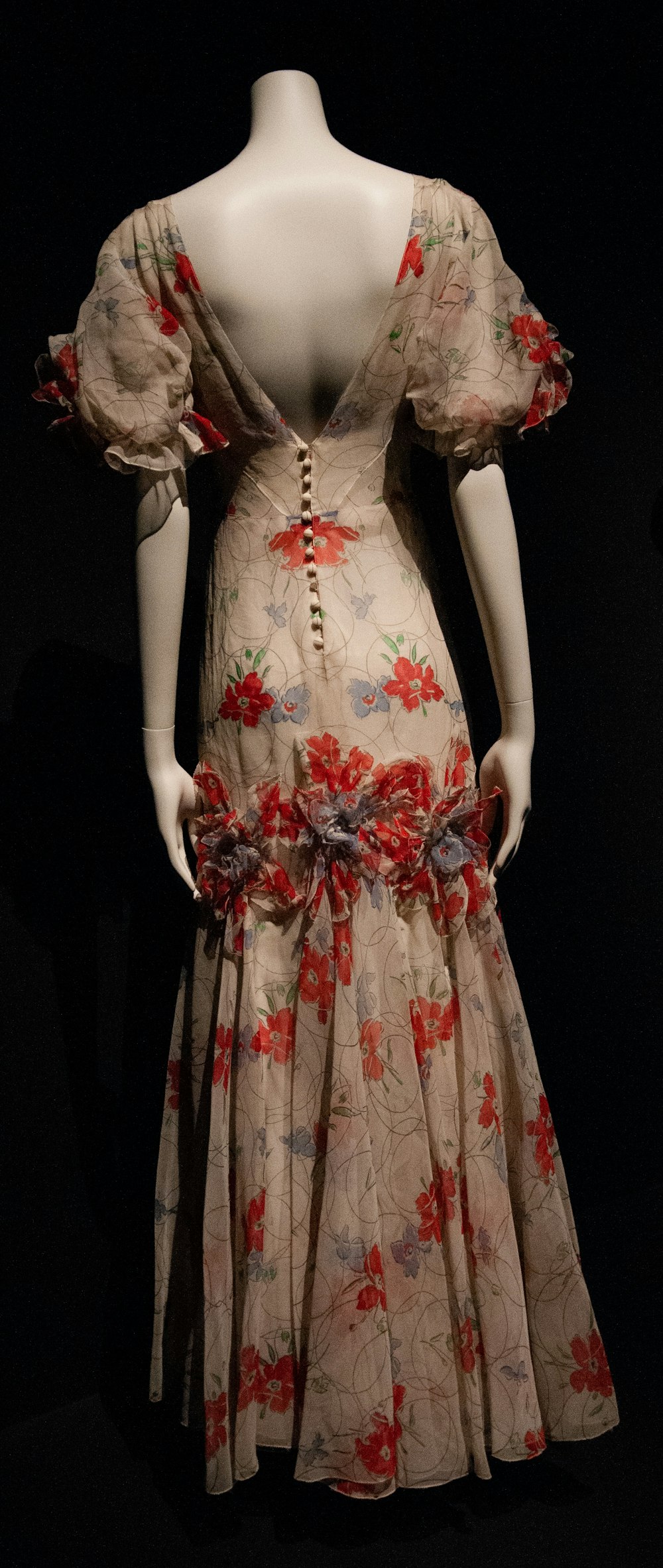 woman in white red and green floral dress