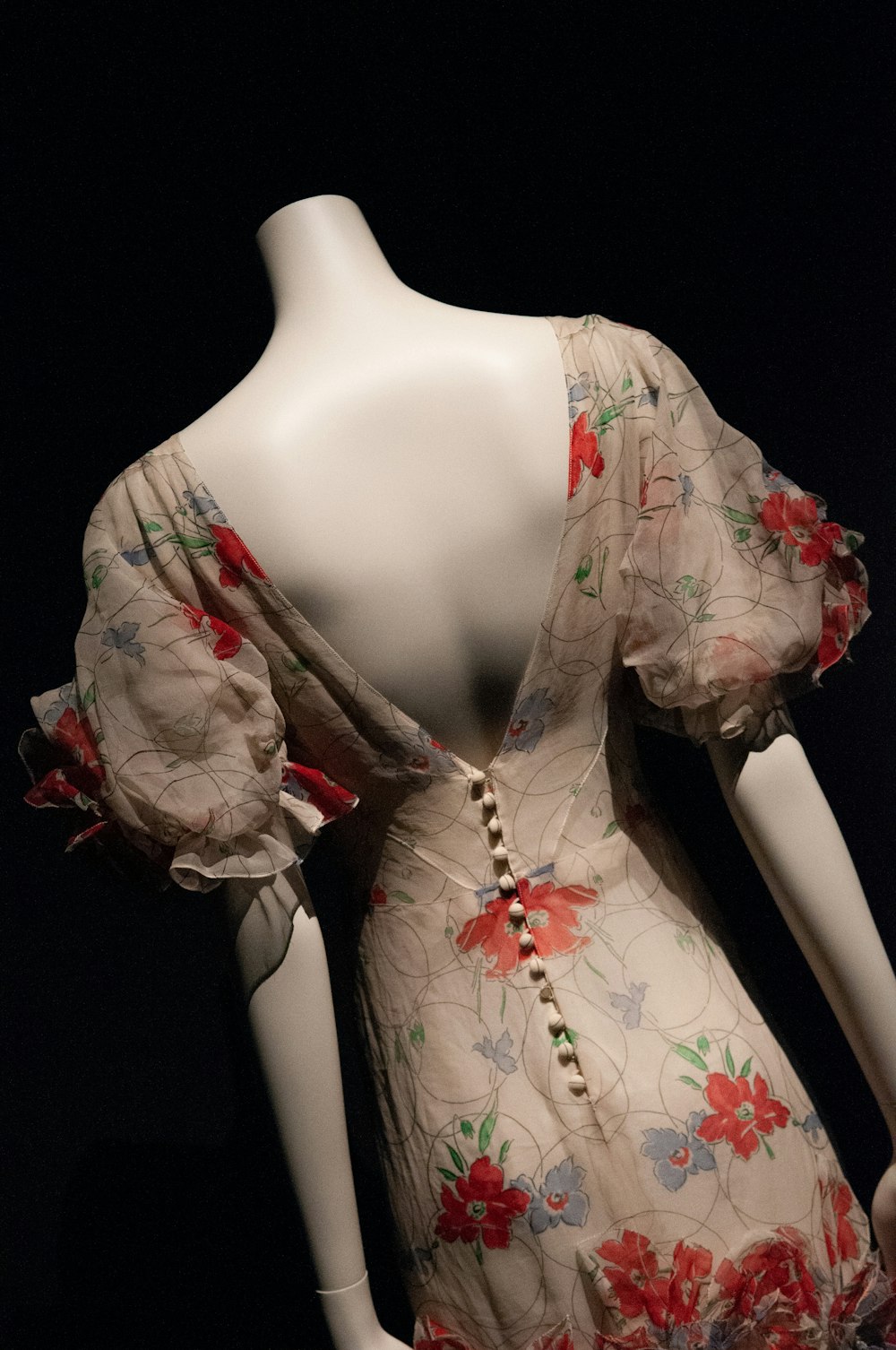 woman in white and red floral dress