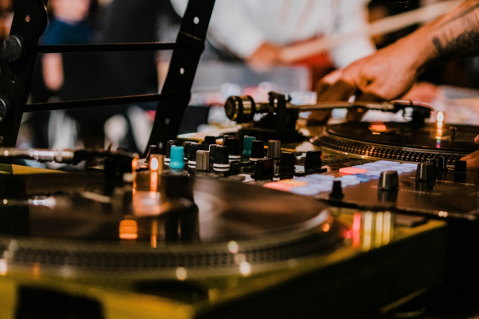 person in white shirt playing dj mixer