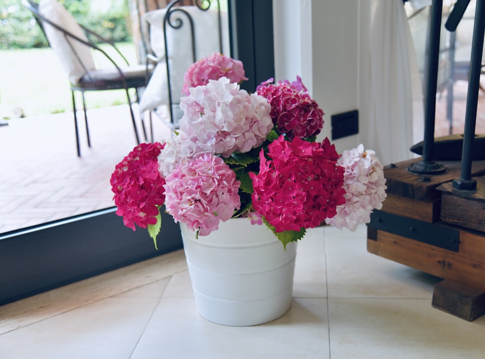 pink flowers in white ceramic vase