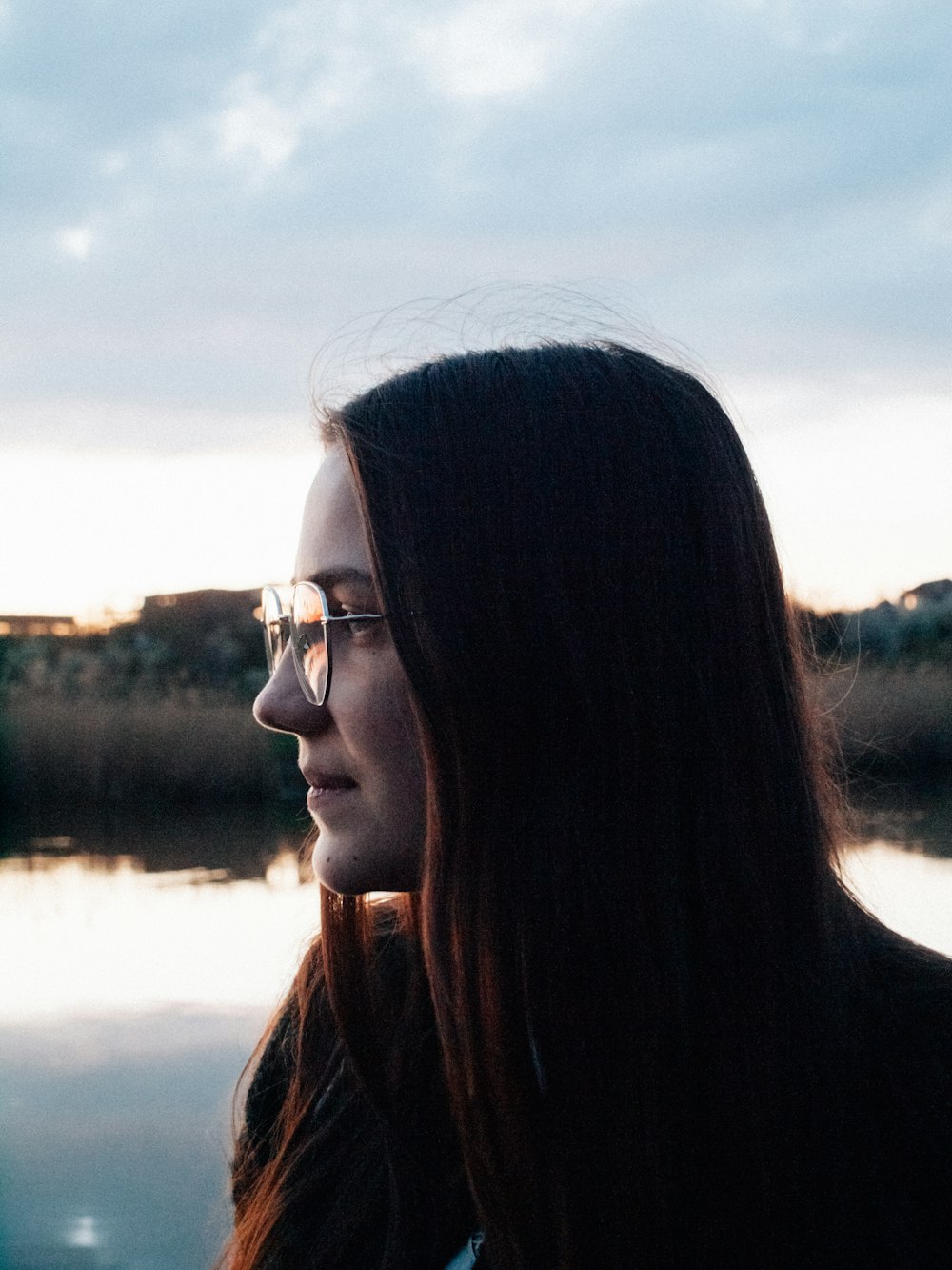 woman in black framed eyeglasses and brown jacket