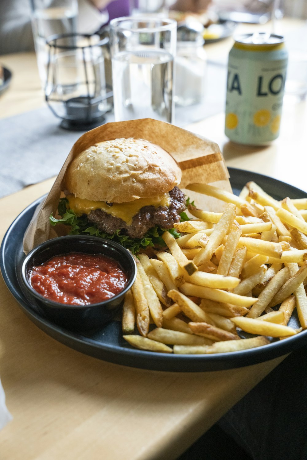 burger and fries on black plate