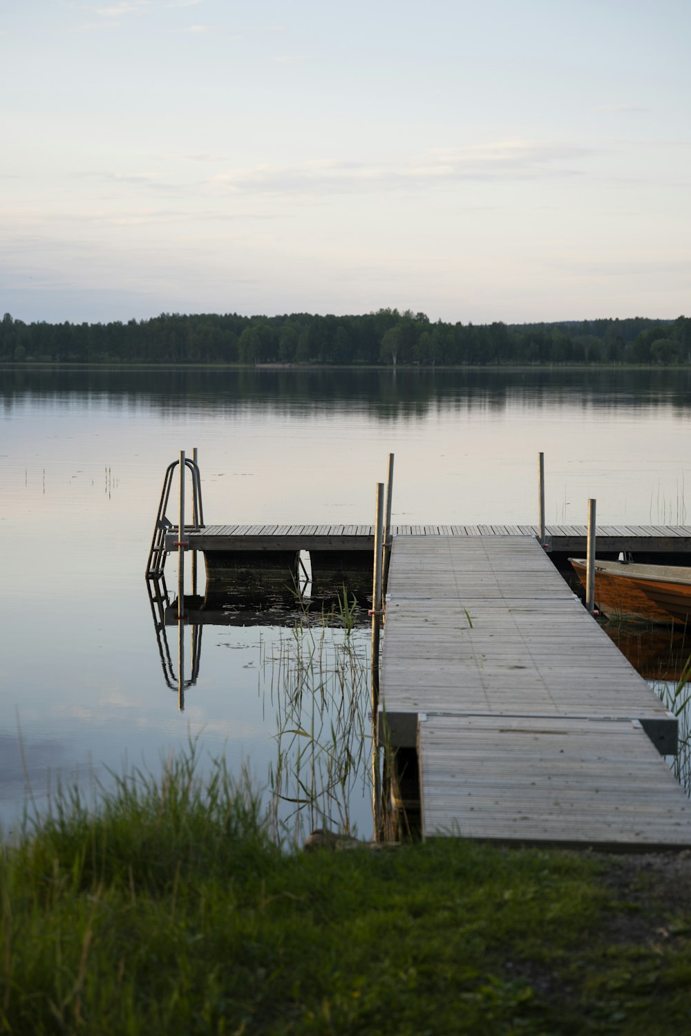 brown wooden dock on lake during daytime