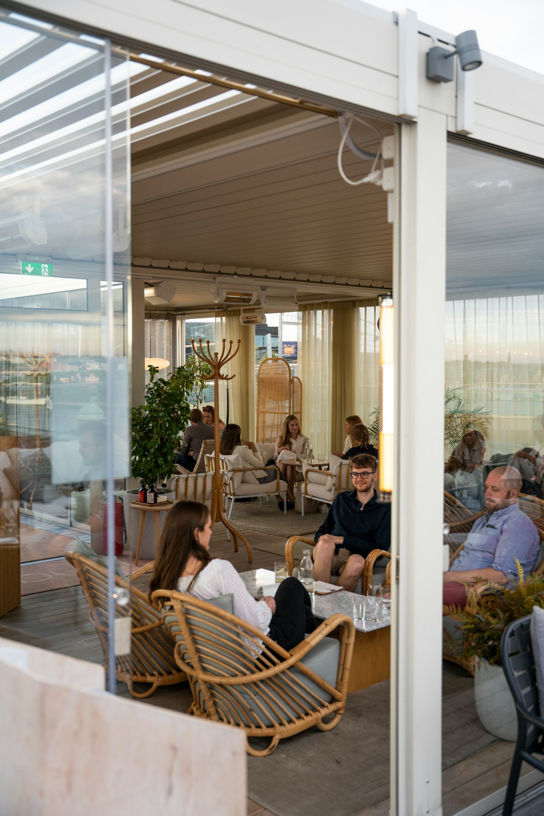 people sitting on brown wooden chairs