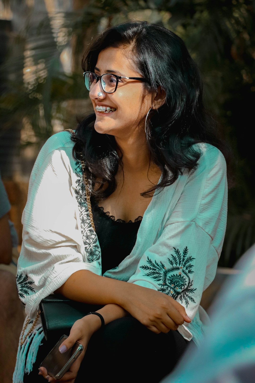 woman in white cardigan and black framed eyeglasses