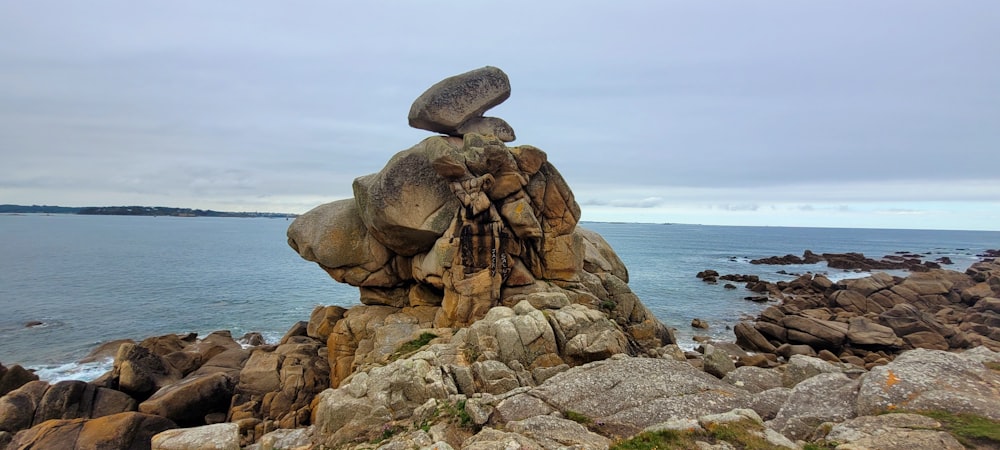 brown rock formation on sea shore during daytime