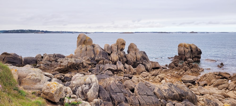 brown rock formation near body of water during daytime