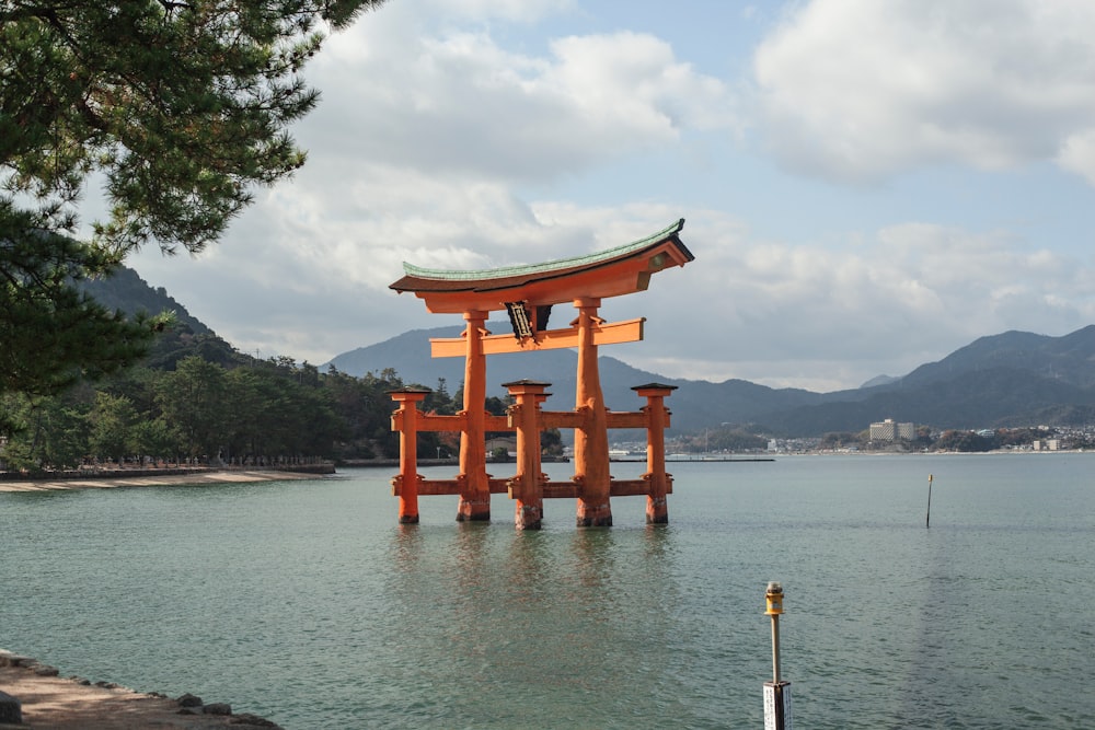 brown wooden arch near body of water during daytime