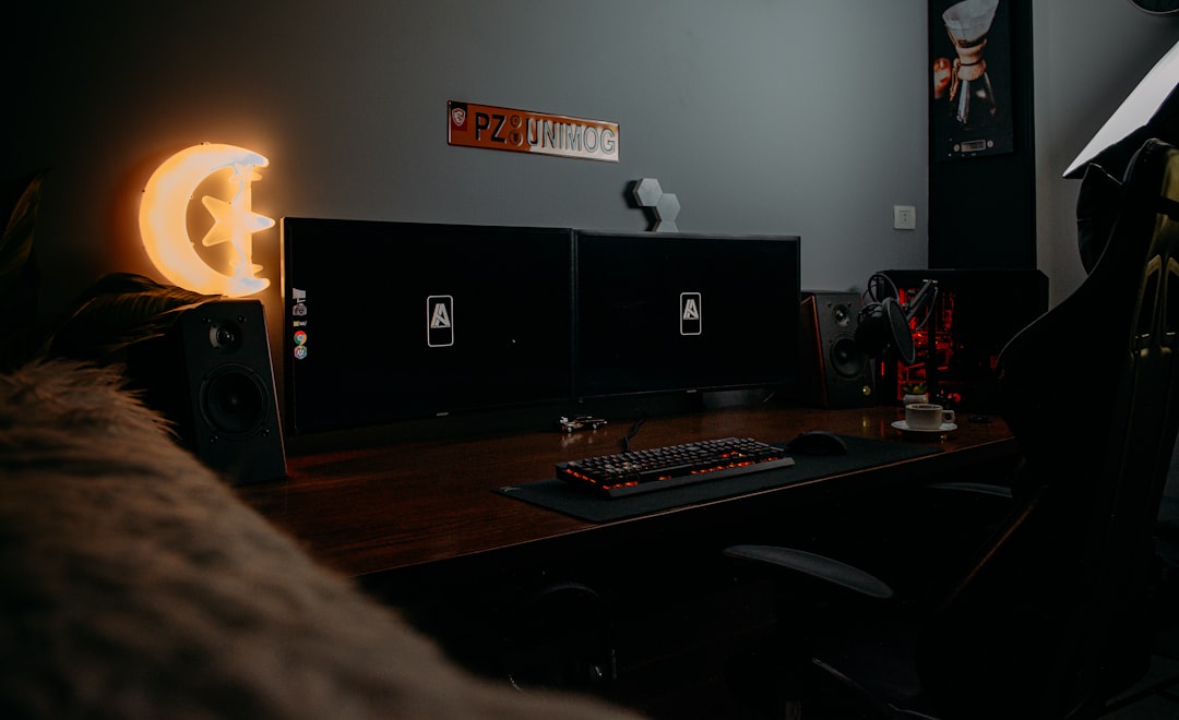 black flat screen computer monitor on brown wooden desk