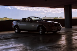 Sunlight streaming through large windows onto a shiny convertible ready for a test drive