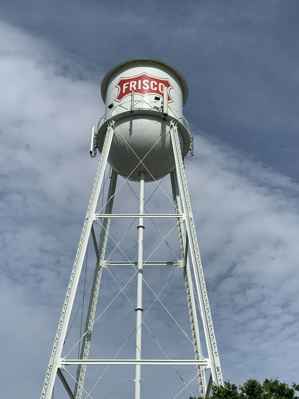 white and red water tank under blue sky