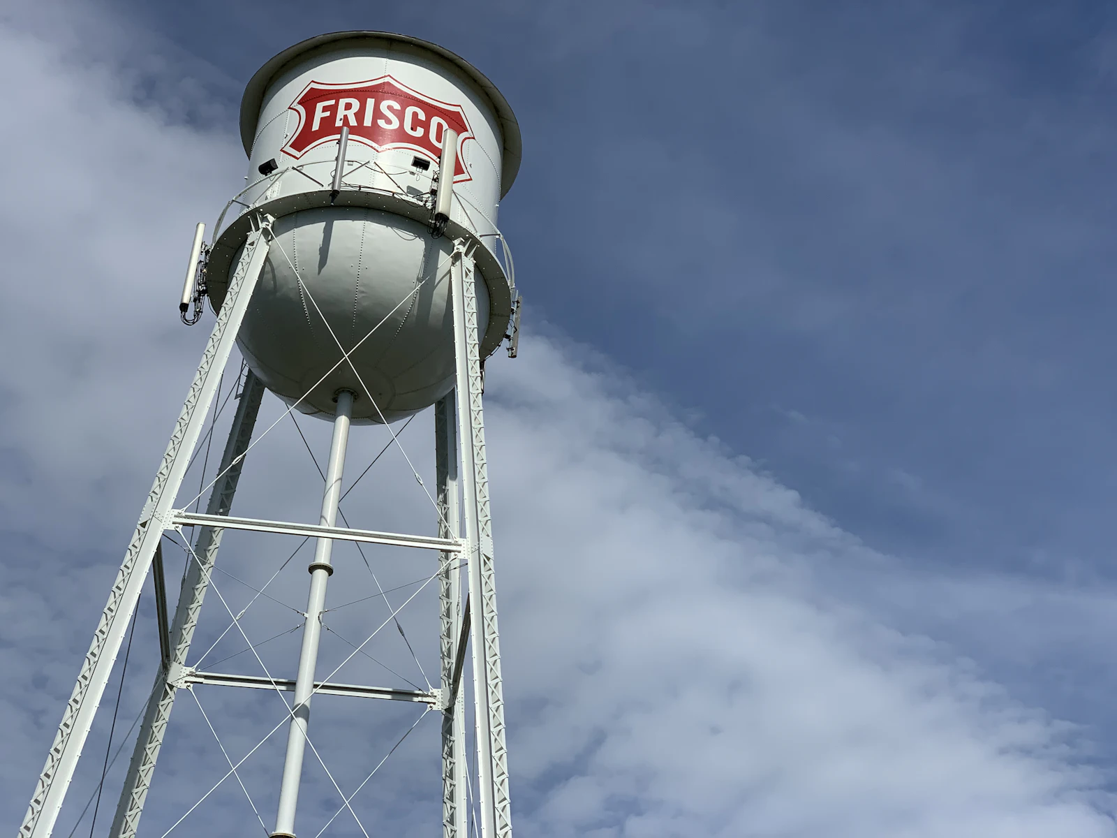 A steel water tower against a cloudy sky.
