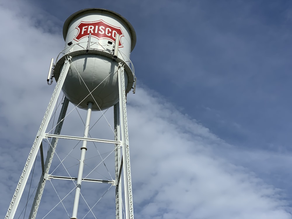 white and red water tank under blue sky during daytime