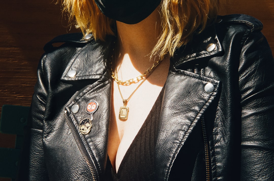 woman in black leather jacket wearing black sunglasses