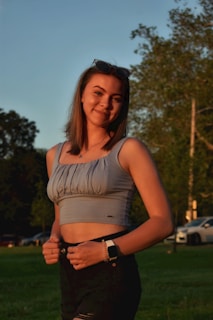 Model wearing lumina apparel pieces in a vibrant urban park setting during golden hour.