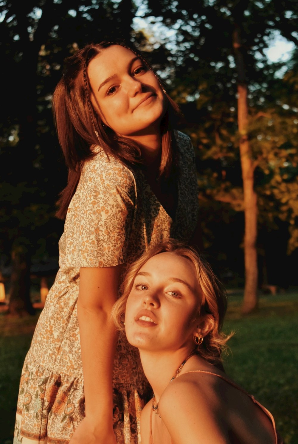 woman in brown floral dress beside woman in gray cardigan