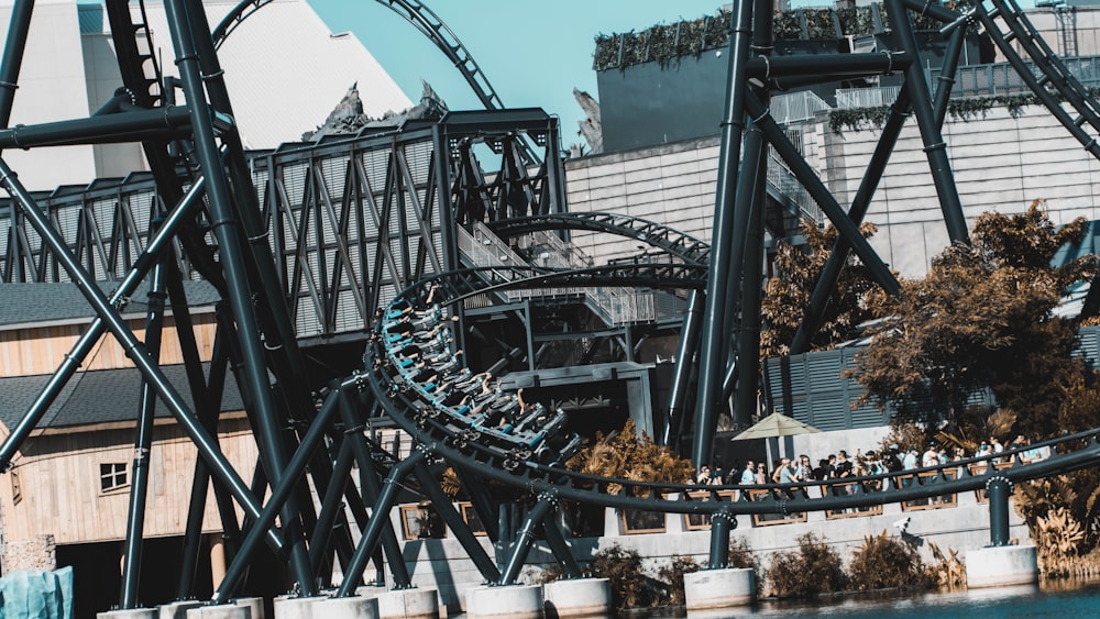 a roller coaster going over a body of water