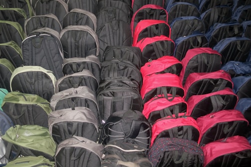 A collection of backpacks hanging on hooks in a bright store