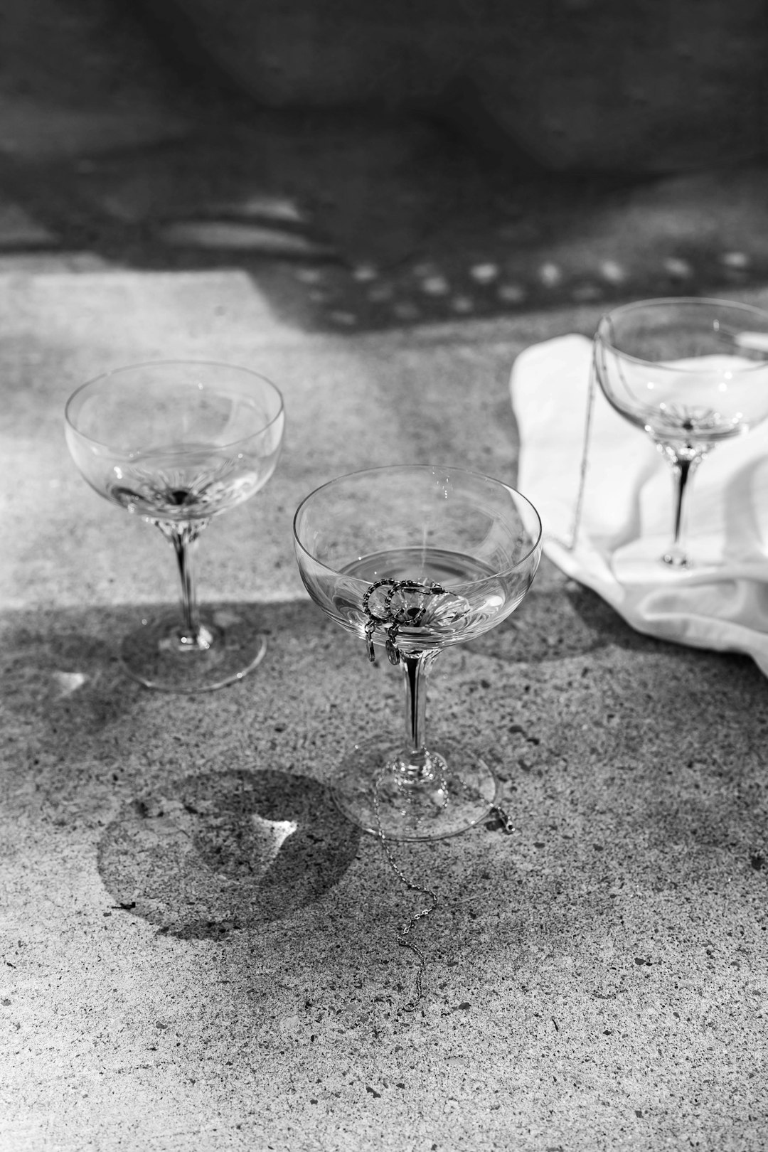 grayscale photo of 2 clear wine glasses