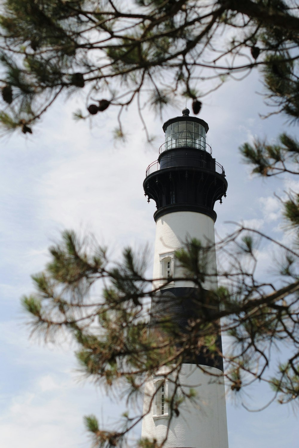 white and black lighthouse under blue sky during daytime