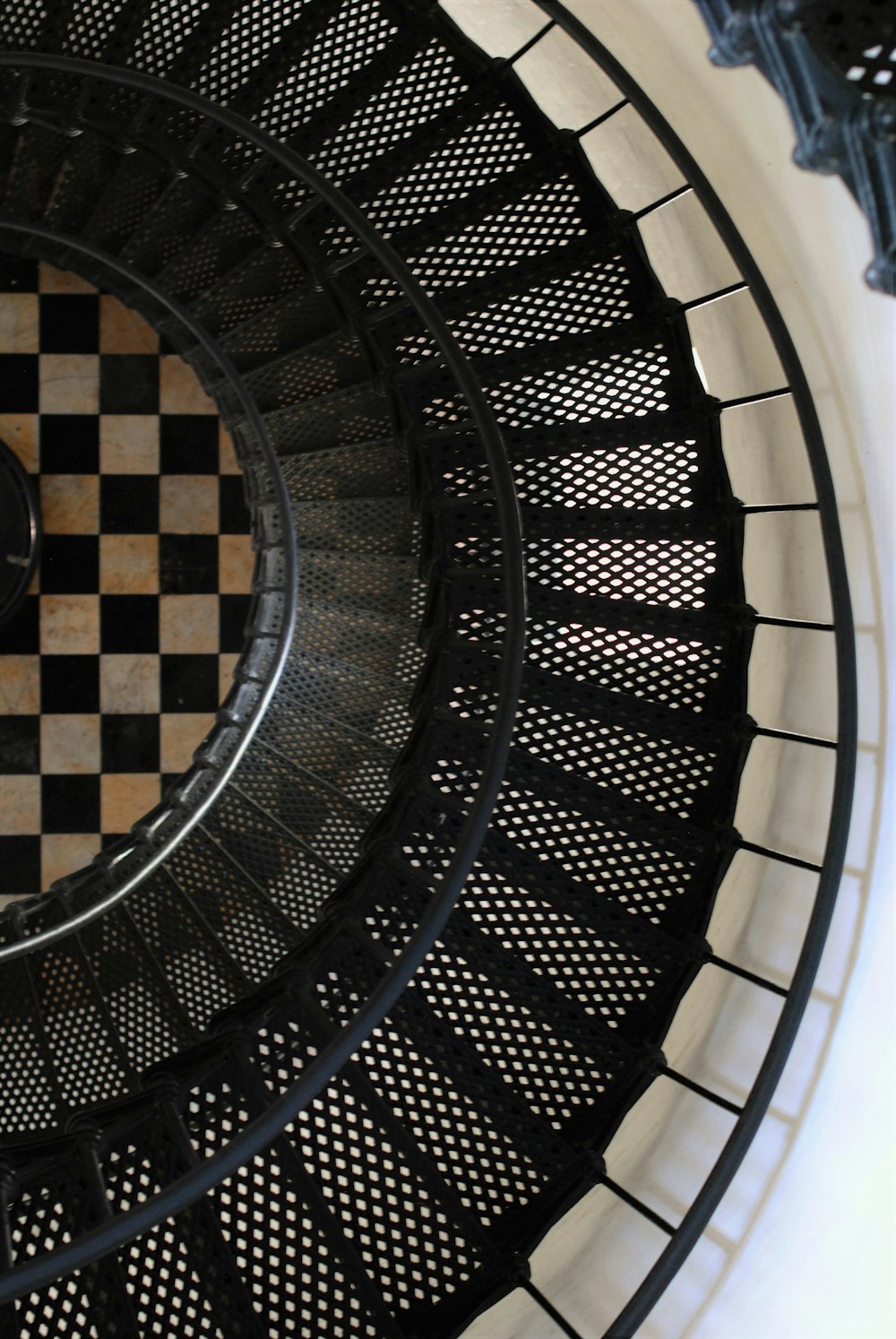 man in black jacket standing on spiral staircase