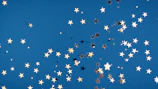 Star-themed party backdrop with shimmering teal fabric and twinkling lights