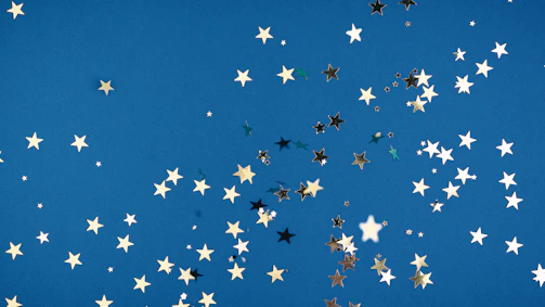 Star-themed party backdrop with shimmering teal fabric and twinkling lights