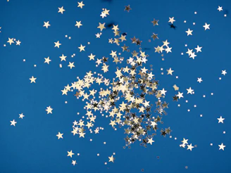 Illustrated stars and playful icons from our brand scattered across a cheerful background.