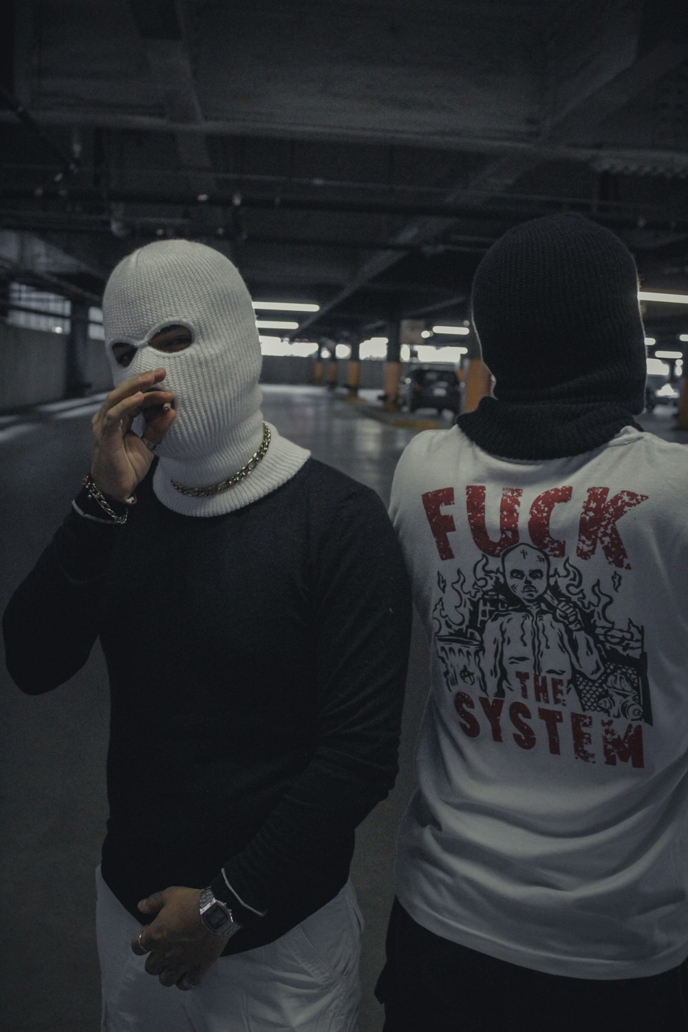 man in black and white hoodie wearing white mask
