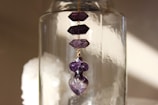Minimalist display of polished amethyst stones with subtle shadows on a smooth surface.
