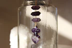 Elegant smoky quartz stones arranged on a deep purple silk cloth with subtle cosmic glow