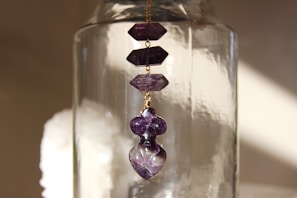 Amethyst bracelet glowing gently with purple hues against a dark velvet cloth